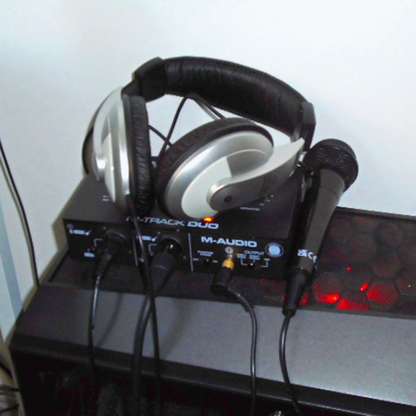 HANDHELD cover: headphones on an audio interface beside a handheld microphone